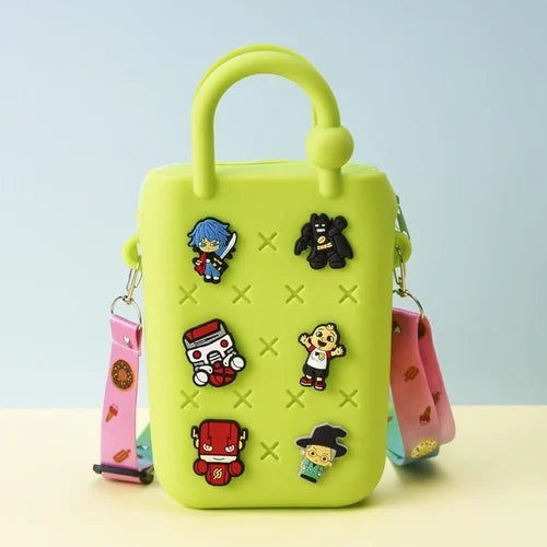 Kids Silicone Sling Bag - Lightweight and Easy to Carry in bright colors with playful cartoon patches and a detachable pastel strap. Ideal for young kids.