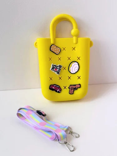 Kids Silicone Sling Bag - Lightweight and Easy to Carry in bright colors with playful cartoon patches and a detachable pastel strap. Ideal for young kids.